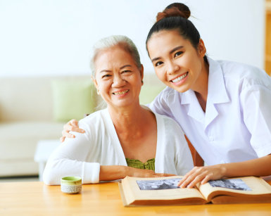 caregiver and senior woman smiling