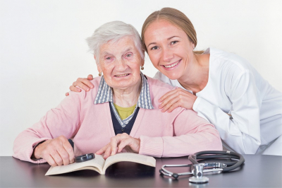 caregiver and senior woman smiling