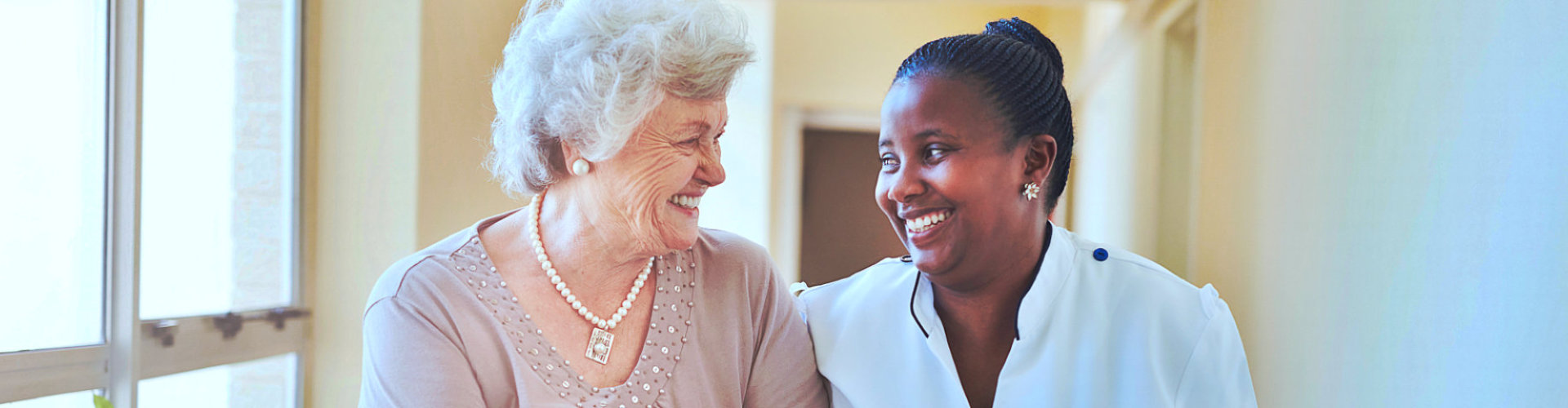 caregiver and senior woman smiling