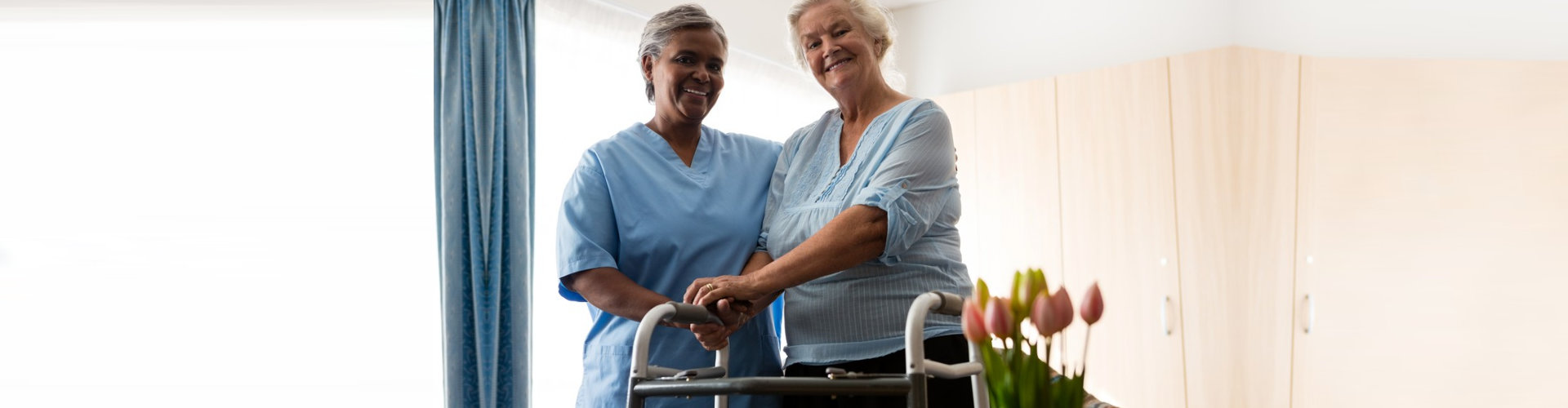 caregiver and senior woman smiling